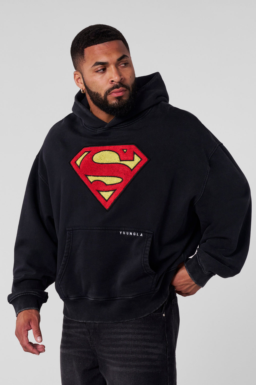 5079 - Superman Legacy Hoodies- Superman Legacy Hoodie in 460 GSM soft cotton with relaxed fit, featuring a chenille Superman logo patch on the chest and a clean acid-washed finish in Black Wash  