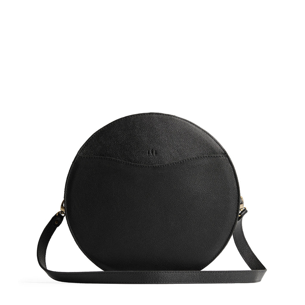 Pebbled--black | Large circle shaped leather bag with top zipper and carrying strap